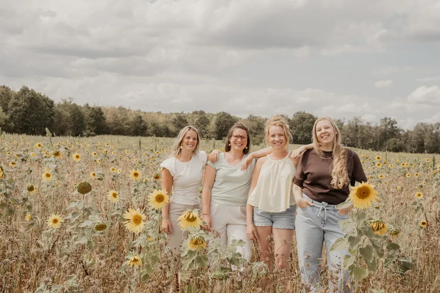 Klik voor een hartje De vier vroedvrouwen van Juno samen in een zonnebloemenveld